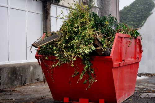 Insured rubbish removal team loading a van